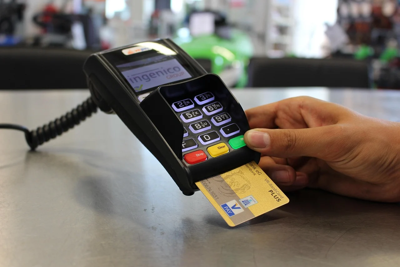 Person reviewing a 0% APR credit card offer while looking at medical bills on a desk