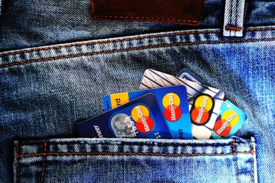 Person reviewing a credit card application and store financing paperwork comparing 0% APR purchase cards
