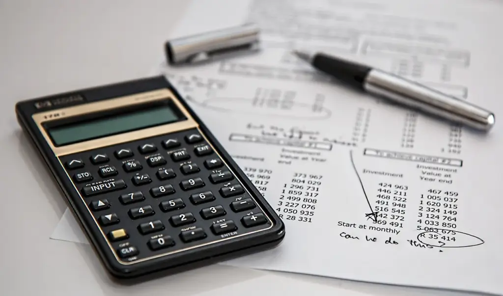 Person reviewing credit card terms and conditions to compare 0% APR credit card offers