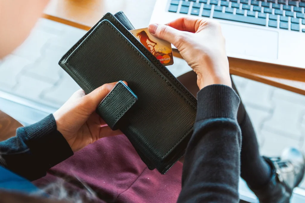 Several credit cards arranged on a desk next to a notebook, illustrating how to stack 0% APR deals
