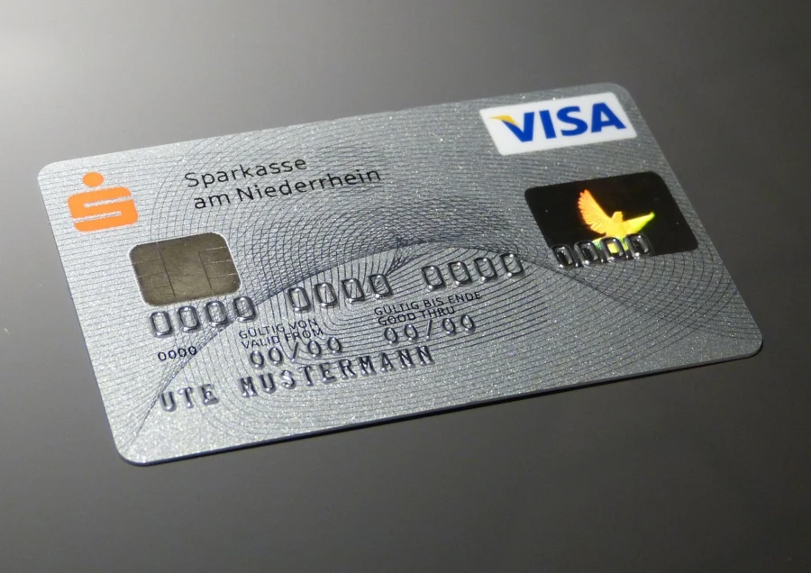 Person smiling while reviewing credit card balance on phone after using a 0% APR card to pay down debt