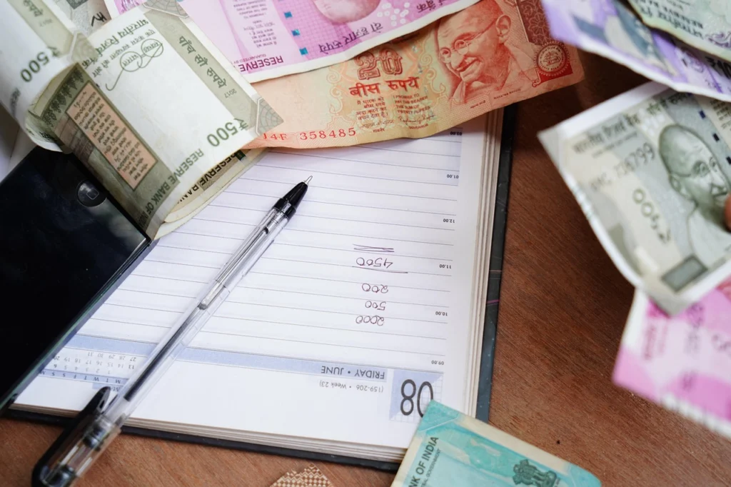 Notebook with a written holiday budget and a 0% APR card payoff schedule